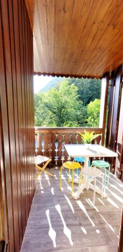 a room with a table and chairs on a porch at Campanules 2 - Abondance in Abondance