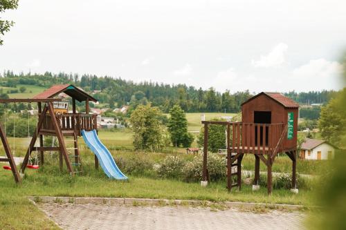 two playground equipment in a field with a slide at Hotel Sonnenhof - Tante ALMA`s Sommerfrische in Sonnen