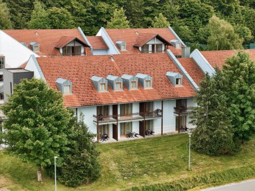 a large building with a red roof at Hotel Sonnenhof - Tante ALMA`s Sommerfrische in Sonnen
