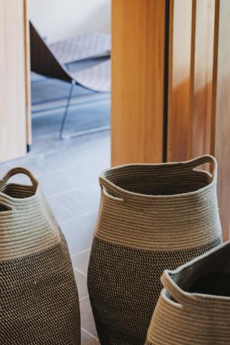 three wicker vases sitting on the floor in a room at Arlberg Lodges in Stuben am Arlberg