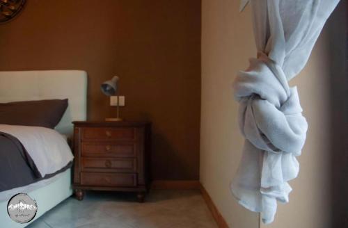 a bedroom with a bed and a towel hanging on the wall at Typical apartment in Valtellina in Sondrio