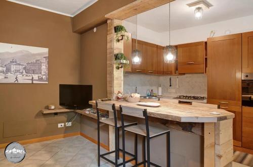 a kitchen with a large island with bar stools at Typical apartment in Valtellina in Sondrio