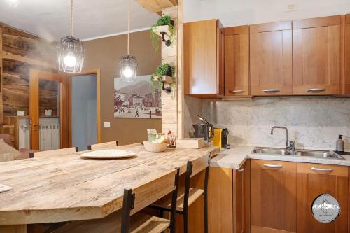 a kitchen with a wooden counter top and a sink at Typical apartment in Valtellina in Sondrio
