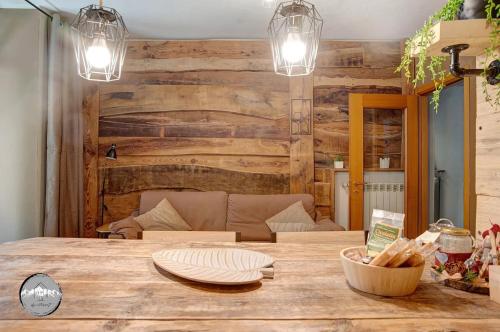 a dining room with a wooden wall and a table at Typical apartment in Valtellina in Sondrio