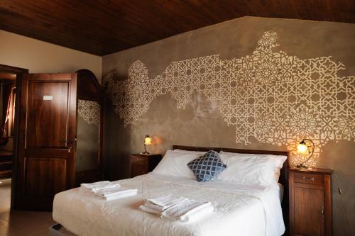 a bedroom with a bed with towels on it at Alle tre Colline in Albugnano 