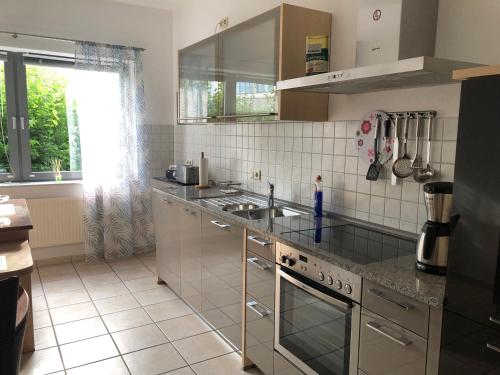 a kitchen with a sink and a counter top at Ferienwohnung Julia in Papenburg