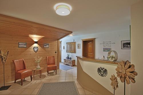 a lobby with chairs and a counter in a room at Haus Hildegard in Gerlos
