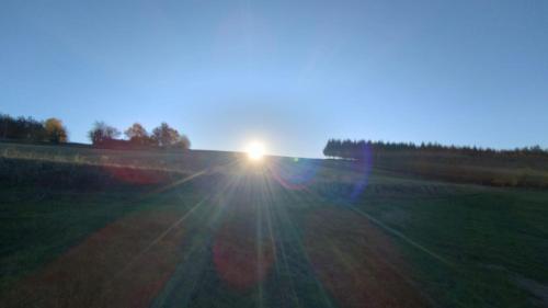 a field with the sun setting in the sky at KOCIEWSKA DACZA - domek o podwyższonym standardzie, POMORSKIE, RZEKA, LASY, ŁĄKI in Pogódki