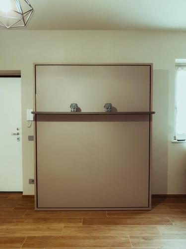 a large sliding door with two glasses on a shelf at Fiore di Langa - Residence in Monforte d'Alba in Monforte dʼAlba