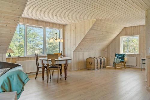 a room with a table and chairs in a attic at 1051-Thisted-Skjaerbakken-57 in Torsted