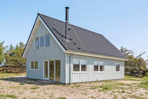a house with a gray roof and windows at 1051-Thisted-Skjaerbakken-57 in Torsted