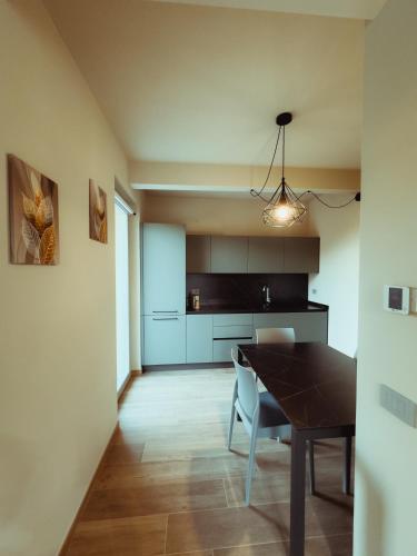 a kitchen and dining room with a table and chairs at Fiore di Langa - Residence in Monforte d'Alba in Monforte dʼAlba