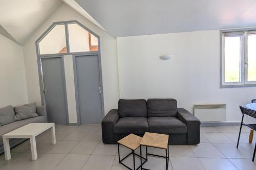 un salon avec un canapé et une table dans l'établissement Charming Apartment in La Rochelle for 4p, à La Rochelle