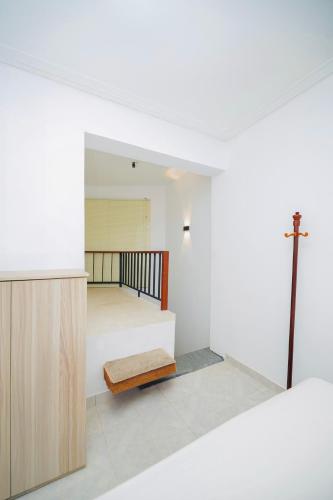 a bedroom with a bed and a cross on the wall at CloudNest Hanthana Kandy in Kandy