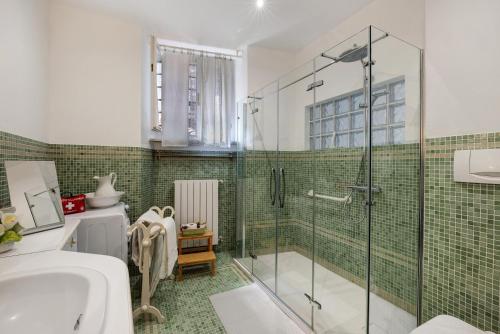 a bathroom with a shower and a toilet and a sink at I Portici Holiday Home in Cairo Montenotte