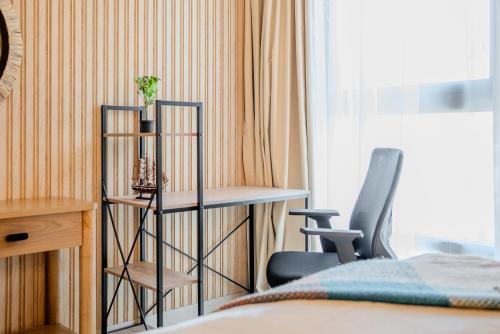 a room with a desk and two chairs and a bed at 2BR Luxury Apartment in Al Zahia Pool View by BlueCloud holidays in Sharjah