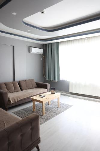 a living room with a couch and a coffee table at Marmara Suit Hotel in Avcılar