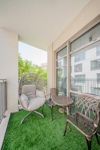 a balcony with a chair and a table at 2BR Luxury Apartment in Al Zahia Pool View by BlueCloud holidays in Sharjah