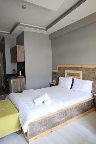 a bedroom with a large bed with white sheets at Marmara Suit Hotel in Avcılar