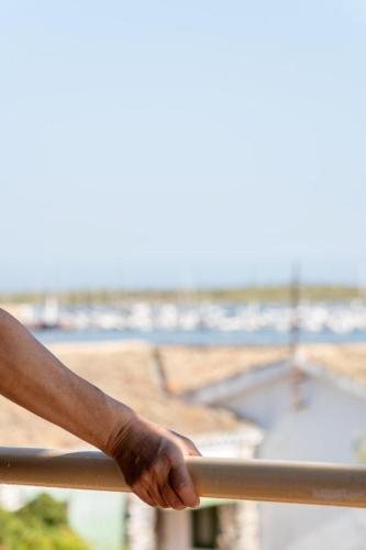 a persons hand on a rail of a fence at Villa Mar Rompido in El Rompido
