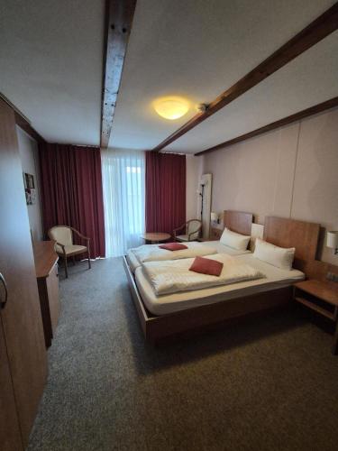 a bedroom with a large bed in a room at Hotel zur Krone in Hasselfelde