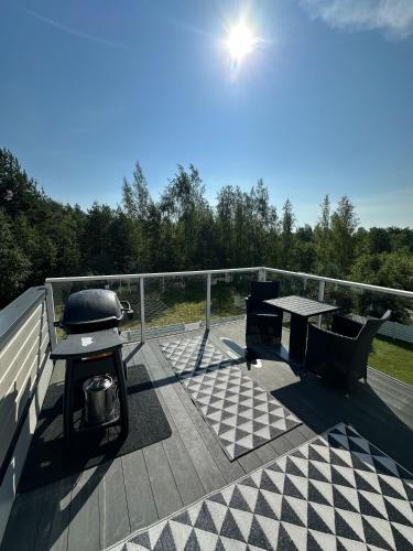 a deck of a boat with a table and a grill at Virpiniemen Maston Villa, Oulu in Oulu