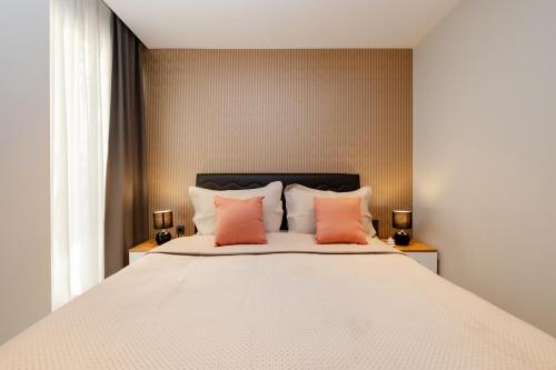 a bedroom with a large bed with orange pillows at Istanbul Apartments in Istanbul