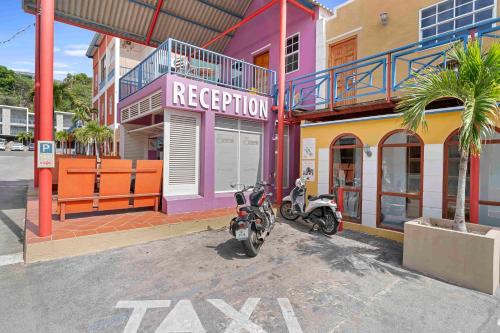 a motorcycle parked in front of a building at The Ritz Hostel in Willemstad