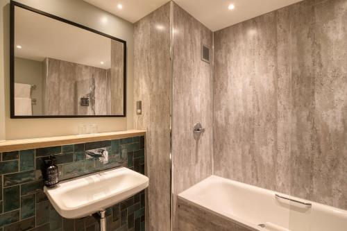 a bathroom with a sink and a mirror at Royal National Hotel in London