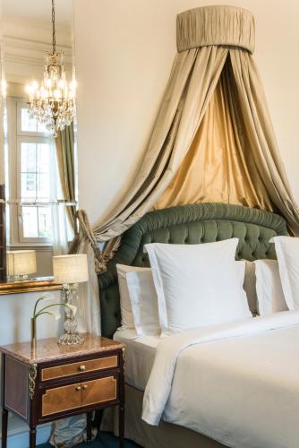 a bedroom with a bed with a green canopy at Four Seasons Hotel Buenos Aires in Buenos Aires