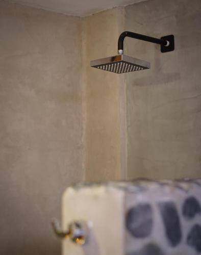 a light hanging over a toilet in a bathroom at Eco Lodge Mancora in Máncora