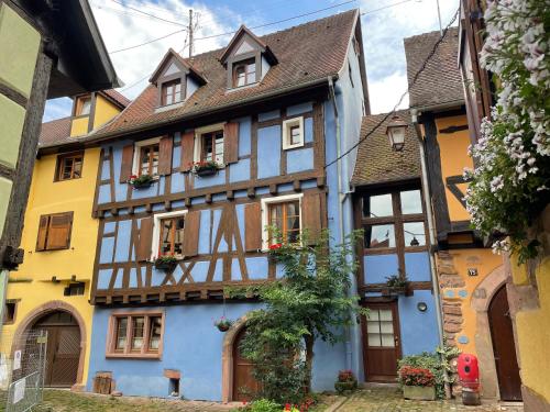a half timbered house in the old town at La Maison Bleue - Historic House in the Heart of Riquewihr in Riquewihr