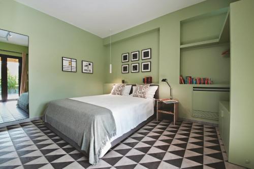 a bedroom with a bed and a checkered floor at ACQUA PETRA Pool Villa & Suites in Agrigento