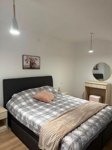 a bedroom with a bed with a blanket on it at Villa Georgi in Ohrid