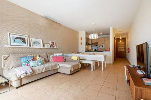a living room with a couch and a table at Casa das Pedras Pretas - By WeHost in Porto Santo