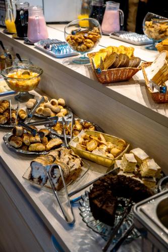 a buffet with many different types of food on display at Pousada Naala Gramado in Gramado