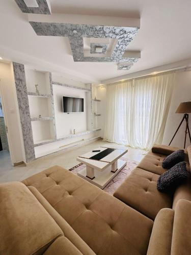 a living room with a couch and a table at APPT T2 lux berr in 'Aïn el Turk