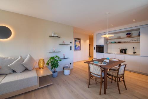 a living room with a couch and a table at Mendelglueck Apartments in Caldaro