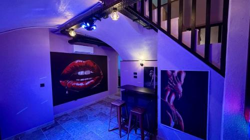 a room with a painting of a mouth on the wall at Love room spa luxe sensoriel in Lyon