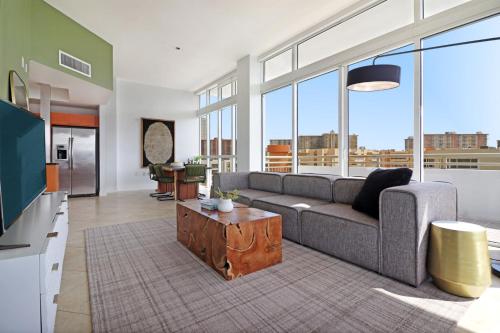a living room with a couch and a table at Roami at Sunny Isles in Miami Beach