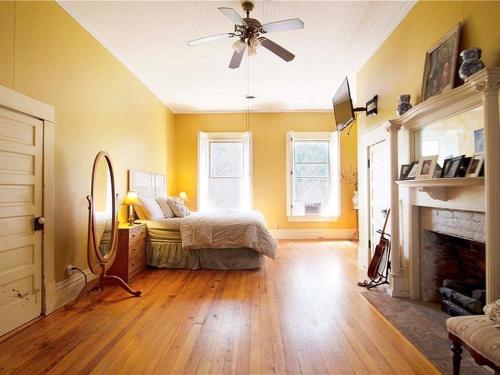 a bedroom with a bed and a ceiling fan at Belton Bed and Breakfast in Belton