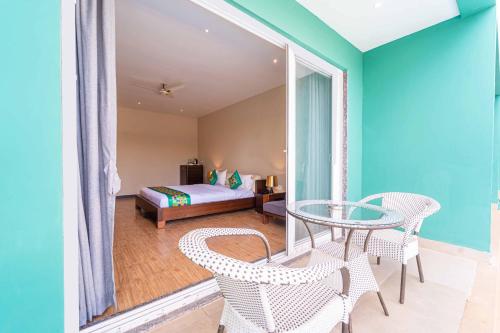 a room with a table and chairs and a bed at Skazka beach resort in Mandrem