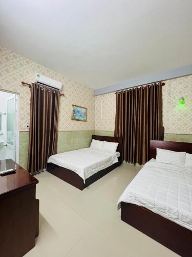 Ένα ή περισσότερα κρεβάτια σε δωμάτιο στο Nhà nghỉ THANH TRÚC