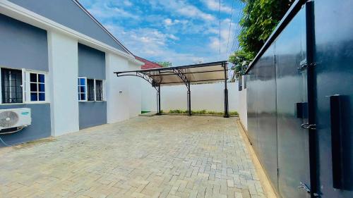 an outside view of a building with a patio at Aliviado Shortlets in Wupa
