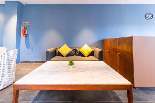 a living room with a couch and a table at Skazka beach resort in Mandrem