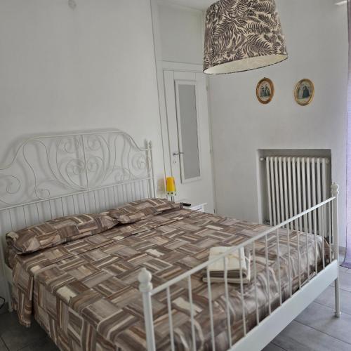 a bedroom with a large bed in a white room at Civico138 in Verona