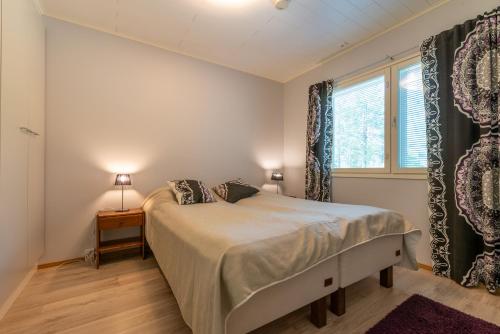 ルカにあるKotokuusi 2 - Monipuoliset ulkoilumahdollisuudet, sisältää siivouksenのベッドと窓のある寝室