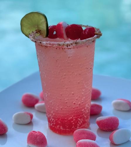 a drink with cherries and a lime on a table at Hotel Aero Santa Fe in Santa Fe de Antioquia