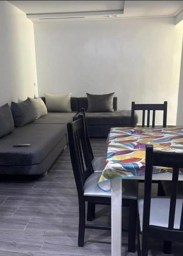 a living room with a couch and a table at appart plage in M'diq