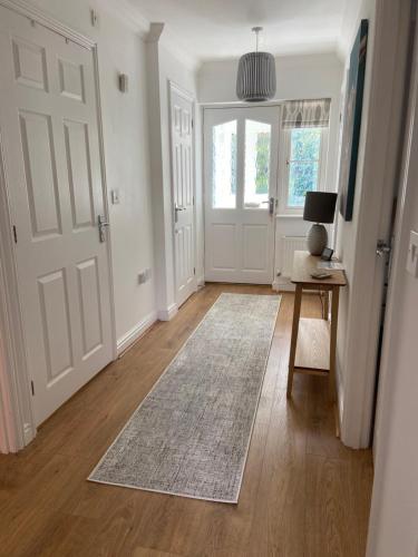 a living room with a door and a rug at Potters Brook in Framlingham